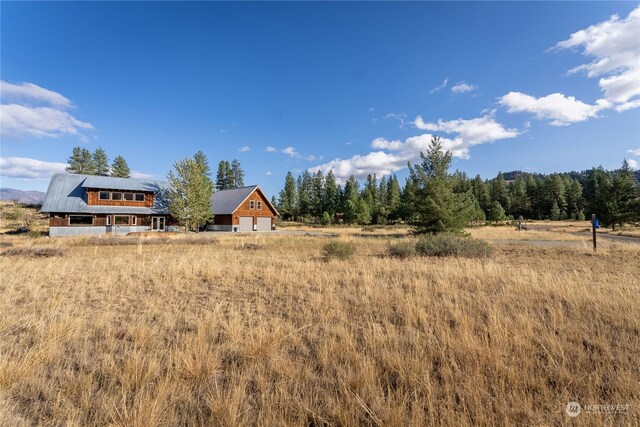 exterior space featuring a garage and a rural view