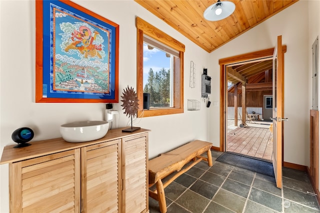 corridor with lofted ceiling, wooden ceiling, and baseboards