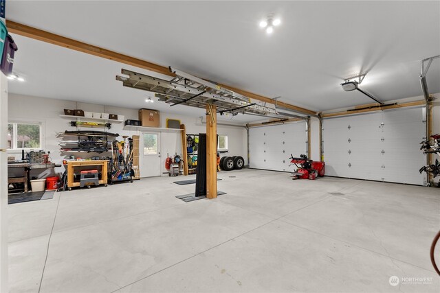 garage featuring a garage door opener and a workshop area