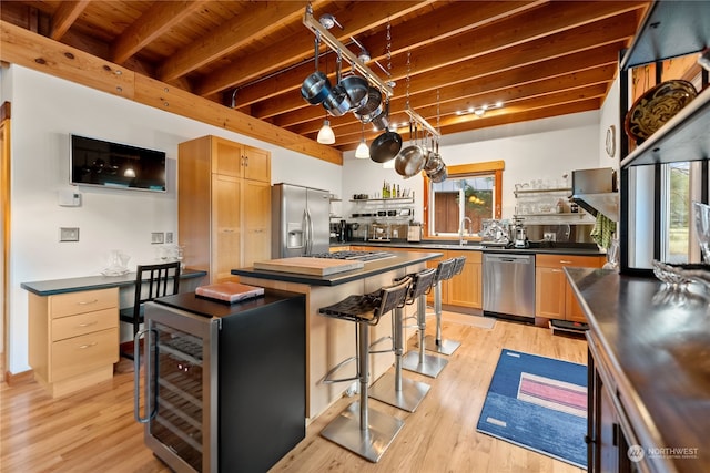 kitchen featuring stainless steel appliances, beverage cooler, beam ceiling, and open shelves