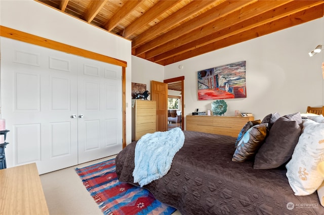 bedroom featuring wooden ceiling, carpet, a closet, and beamed ceiling