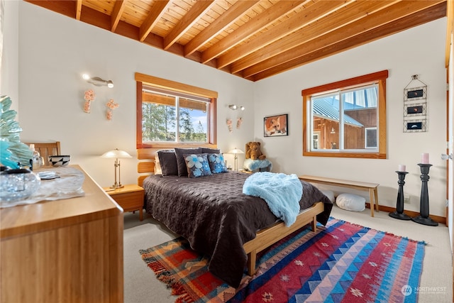 bedroom with beamed ceiling, carpet flooring, wood ceiling, and baseboards