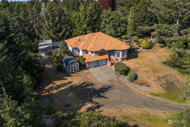 drone / aerial view featuring a forest view