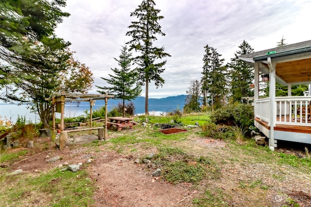 view of yard featuring a deck with water view