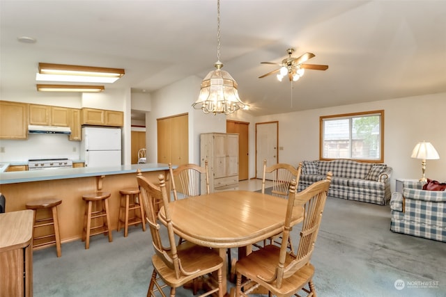 dining room with light colored carpet and ceiling fan with notable chandelier