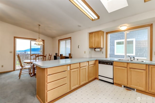 kitchen featuring a mountain view, dishwasher, plenty of natural light, kitchen peninsula, and lofted ceiling with skylight