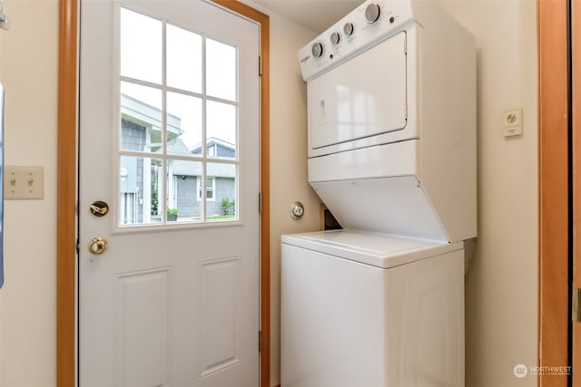 laundry area with stacked washer and clothes dryer