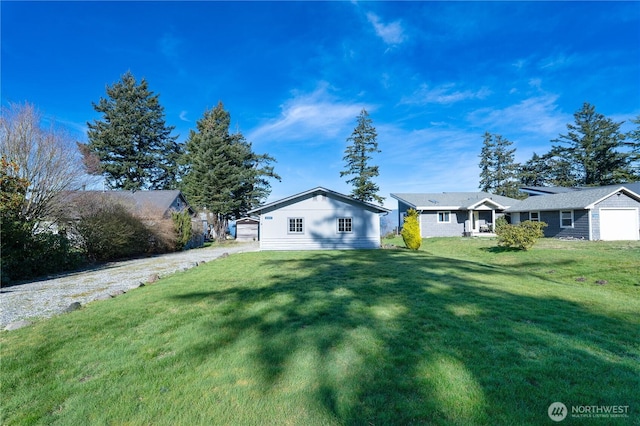 view of front of house featuring a garage and a front lawn