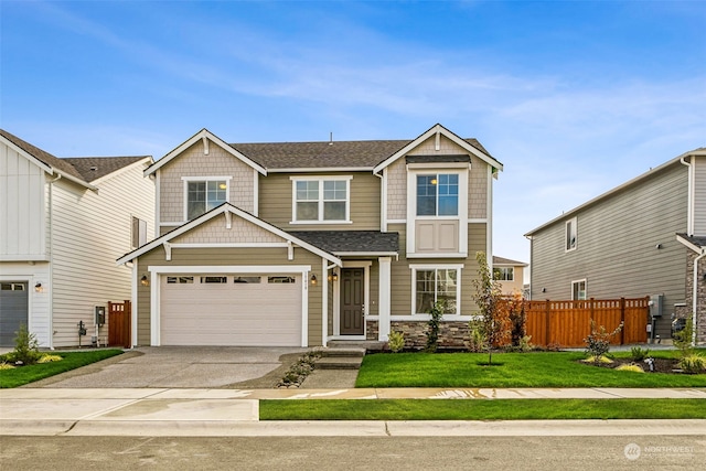 craftsman-style house featuring a front yard and a garage