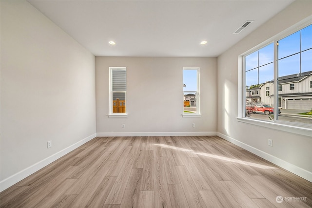 empty room with light hardwood / wood-style floors