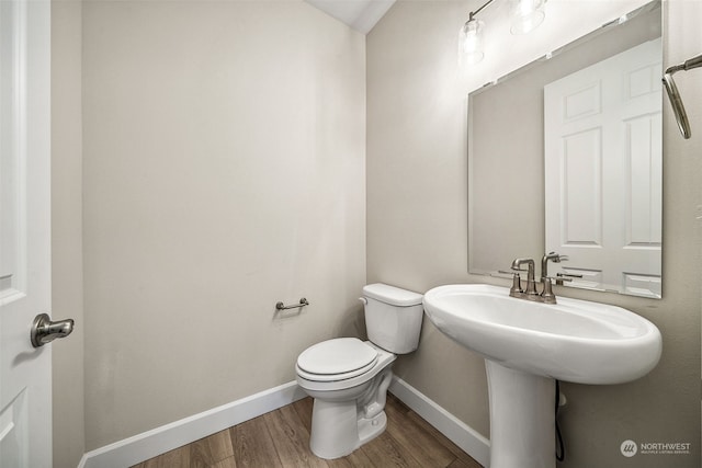 bathroom featuring toilet and hardwood / wood-style flooring