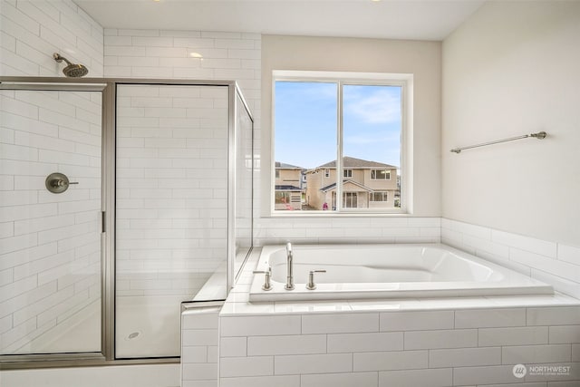 bathroom with shower with separate bathtub