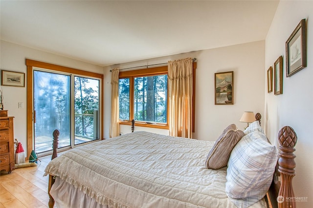 bedroom with light wood-style floors and access to exterior