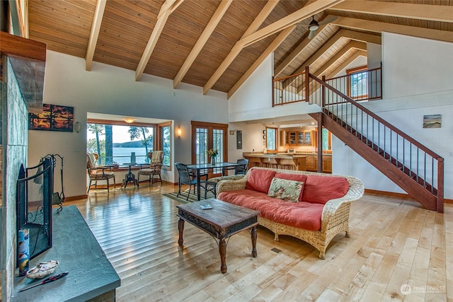 living room featuring baseboards, wooden ceiling, beamed ceiling, stairs, and wood-type flooring