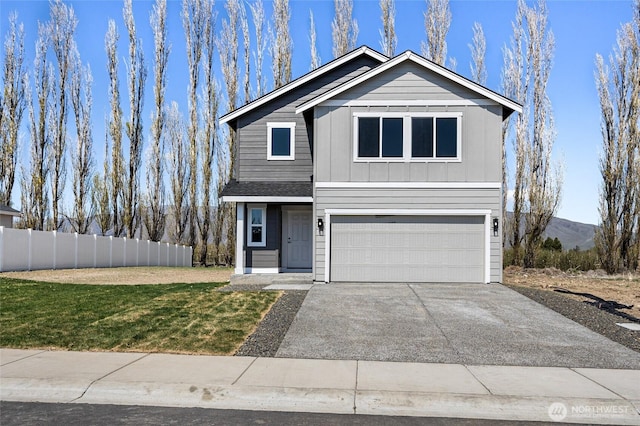 518 Chinook Winds Ln, Tieton, WA 98947 - traditional-style house with board and batten siding, fence, an attached garage, concrete driveway, and a front yard