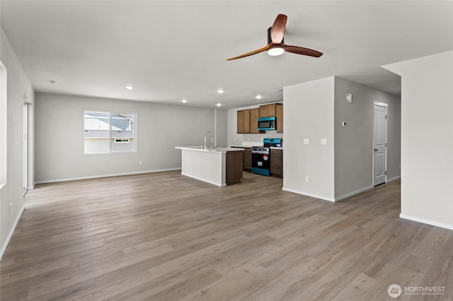518 Chinook Winds Ln, Tieton, WA 98947 - unfurnished living room with baseboards, light wood finished floors, ceiling fan, and a sink