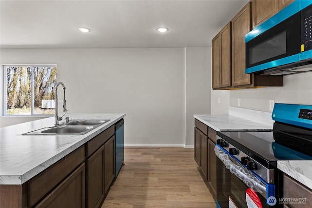 518 Chinook Winds Ln, Tieton, WA 98947 - kitchen featuring dishwashing machine, a sink, stainless steel electric range, light countertops, and light wood-style floors
