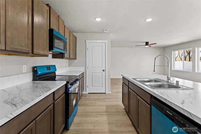518 Chinook Winds Ln, Tieton, WA 98947 - kitchen with a ceiling fan, light wood-style flooring, dishwasher, electric range oven, and a sink
