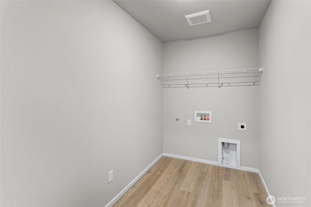 518 Chinook Winds Ln, Tieton, WA 98947 - laundry area with baseboards, hookup for a washing machine, light wood finished floors, laundry area, and electric dryer hookup