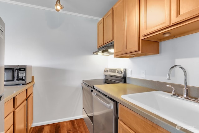 kitchen featuring ornamental molding, dark hardwood / wood-style flooring, light brown cabinetry, sink, and appliances with stainless steel finishes