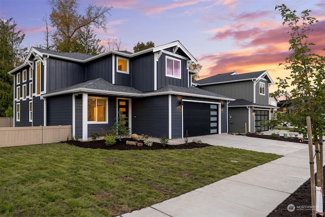 view of front of house featuring a yard and a garage