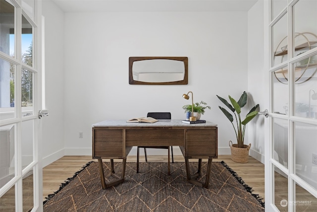 office with french doors and hardwood / wood-style flooring