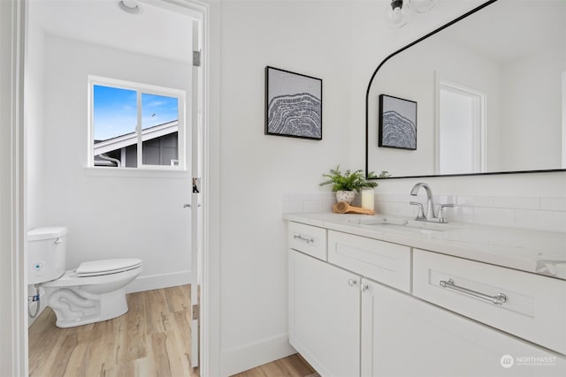 bathroom featuring hardwood / wood-style flooring, vanity, and toilet