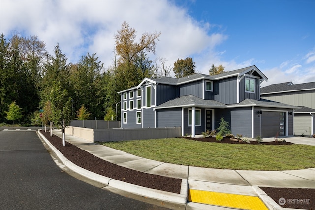 view of front of property with a garage and a front lawn