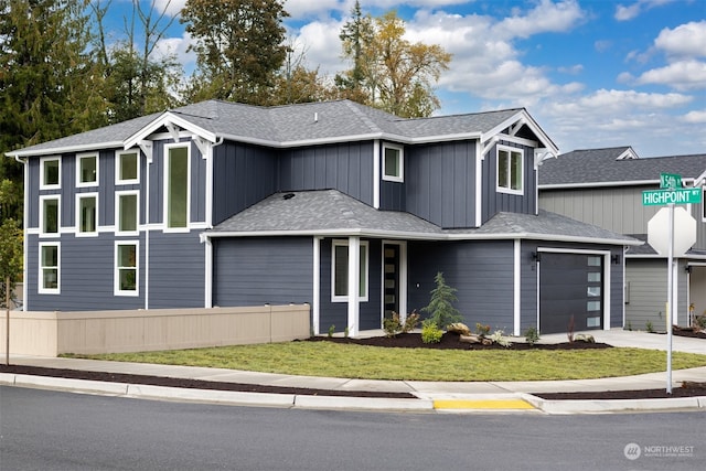 view of front of home featuring a garage and a front lawn