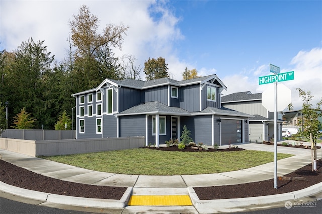 view of front facade featuring a front yard and a garage