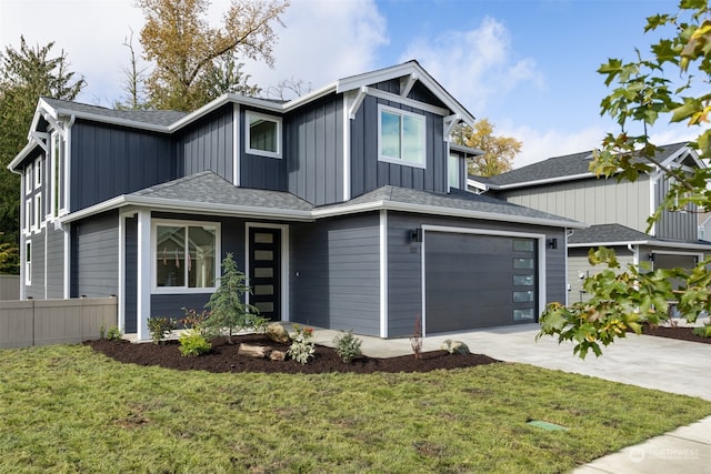 view of front of home with a garage and a front lawn