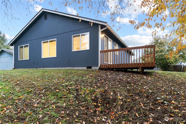 view of home's exterior with a wooden deck