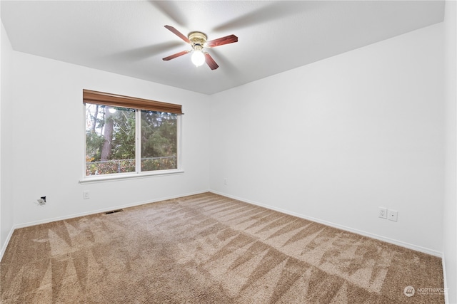 unfurnished room with carpet and ceiling fan