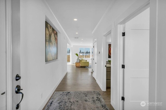 hall featuring wood-type flooring and ornamental molding