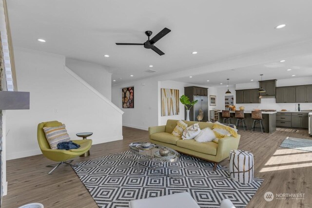 living room with hardwood / wood-style flooring and ceiling fan