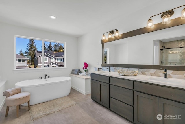 bathroom featuring vanity and independent shower and bath