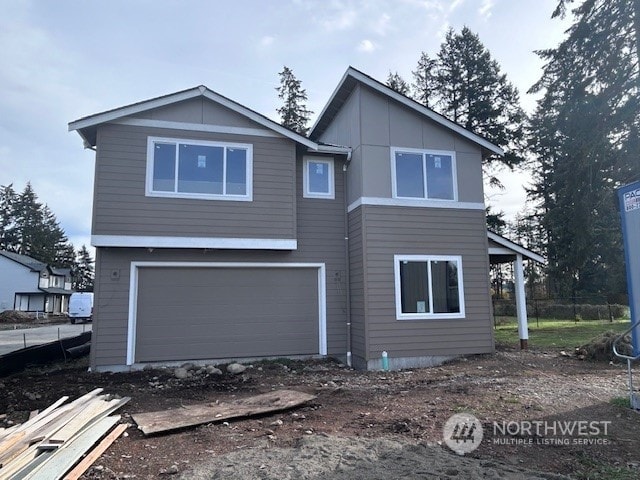 rear view of property with a garage