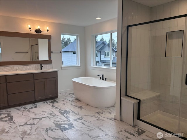 bathroom with a freestanding bath, recessed lighting, a stall shower, marble finish floor, and vanity