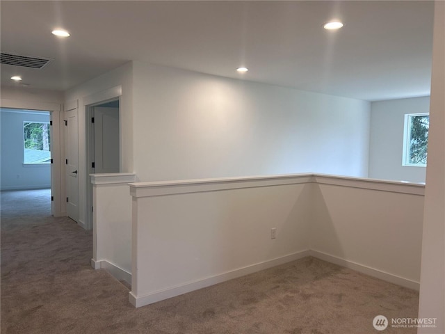 carpeted empty room with recessed lighting, visible vents, and baseboards