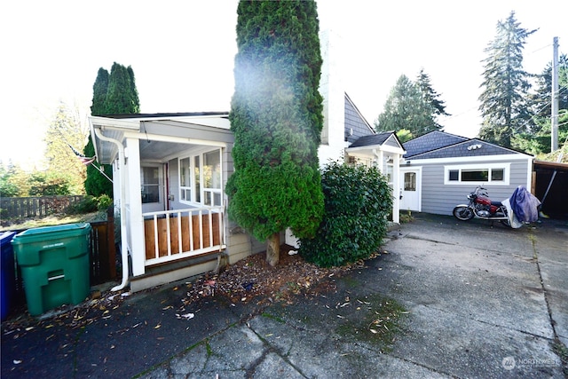 view of side of home with a garage and an outbuilding