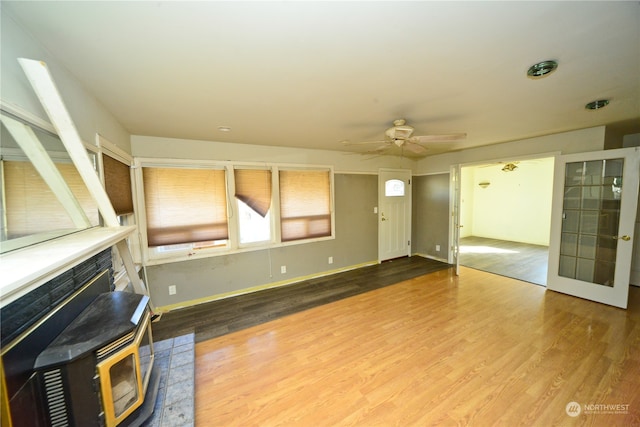 unfurnished living room featuring hardwood / wood-style floors and ceiling fan