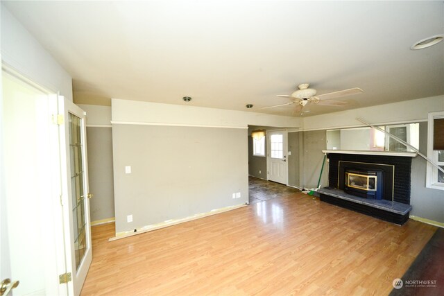 unfurnished living room featuring wood-type flooring and ceiling fan