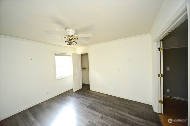 unfurnished room with crown molding, dark hardwood / wood-style floors, and ceiling fan