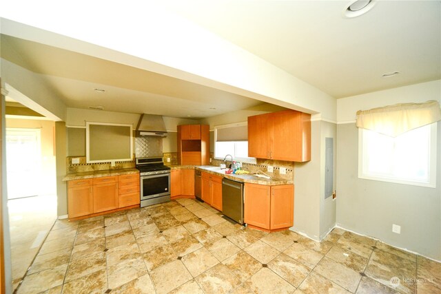 kitchen featuring stainless steel appliances, decorative backsplash, a wealth of natural light, and premium range hood