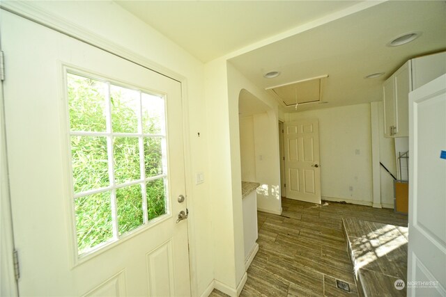 doorway to outside with dark wood-type flooring