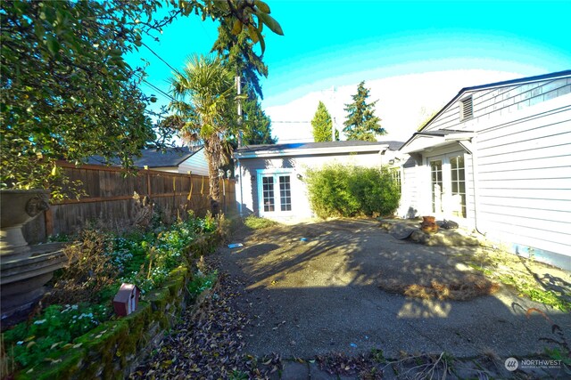 view of yard with french doors and a patio