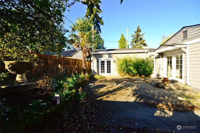 view of yard featuring a patio area and french doors