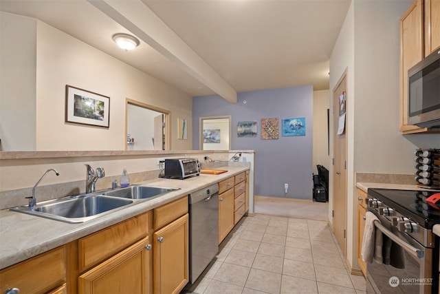 kitchen with light brown cabinets, sink, light tile patterned floors, and stainless steel appliances