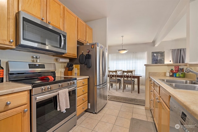 kitchen featuring hanging light fixtures, light tile patterned floors, beam ceiling, sink, and stainless steel appliances