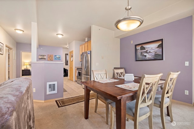 dining room featuring light carpet